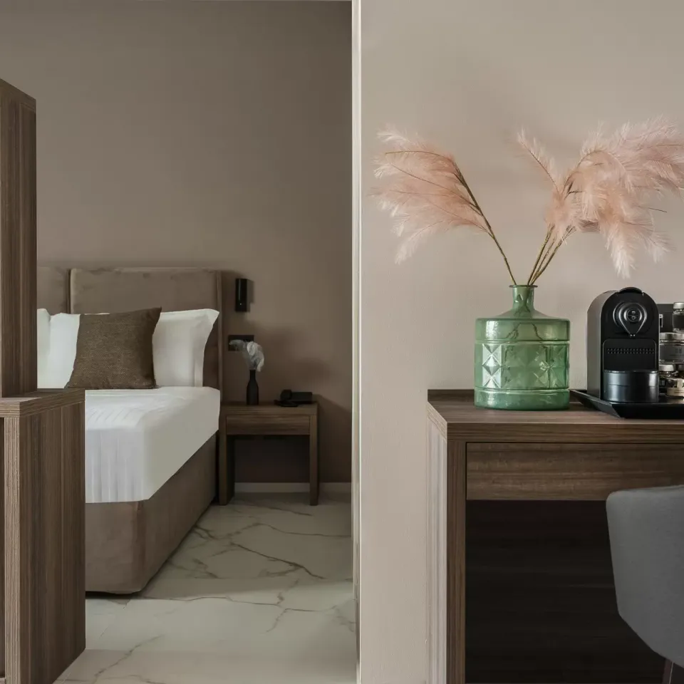 Camera moderna con letto, TV, macchina da caffè e decorazioni eleganti.